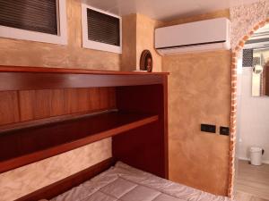 a tiny house with a built in bunk bed at Tiny house in Puebla de Vallbona