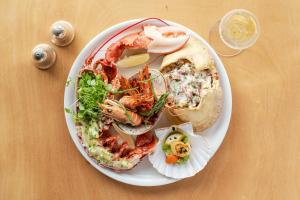 a plate of food with seafood on a table at Watersmeet Hotel in Woolacombe