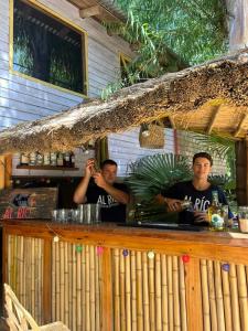 two men standing at a bar in front at Cabañas AlRío Quietud en Movimiento in Tigre