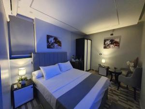 a bedroom with a large bed and a chair at Youvala serviced apartment Giza in Cairo
