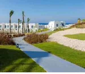 a walkway in front of a beach with buildings at Mountain view North Coast Ras elhekma, Tart's Home, Families only in Ras Elhekma