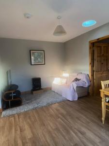 a bedroom with a bed and a tv in it at Kilmore Beach Apartment in Tralee