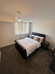 a bedroom with a large bed and a window at Flat 1 - Luxury Bolton City Centre Apartments in Bolton +52 photos