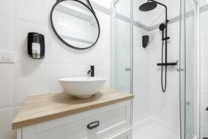 a bathroom with a white sink and a mirror at Mahalo Home in Porriño +17 photos