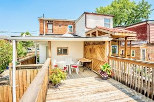 a house with a wooden deck with a table at 3BR Luxury Home - Heart of St Clair West in Toronto