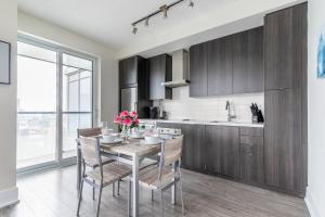 a kitchen with a table with flowers on it at Luxury 1BR Condo - King Bed with City Views in Toronto