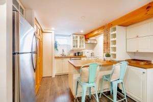 a kitchen with a table and chairs and a refrigerator at Modern 1BR Home - Minutes From High Park in Toronto