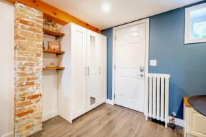 a room with a white door and a brick wall at Modern 1BR Home - Minutes From High Park in Toronto