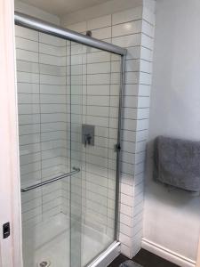 a shower with a glass door in a bathroom at Best Choice Apartment in Vancouver