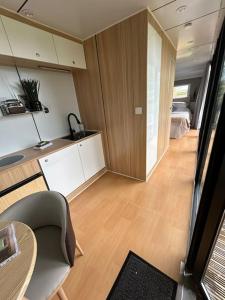 a room with a kitchen and a room with a bed at Countryside Pod Retreat in Durston