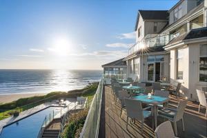 a balcony of a house with a view of the ocean at Watersmeet Hotel in Woolacombe