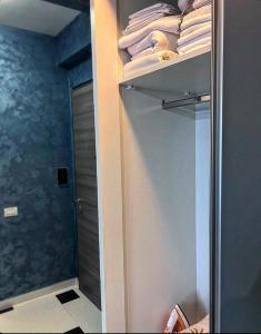 a bathroom with a closet with white towels and a shower at Azul Sunrise in Mamaia Sat/Năvodari