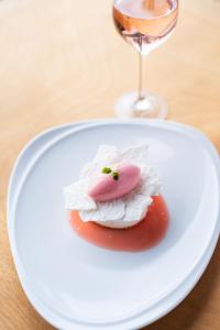 a white plate with a dessert and a glass of wine at Watersmeet Hotel in Woolacombe