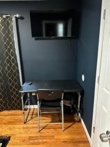 uma mesa preta e uma cadeira num quarto em Fidelia Room B Queen Bed Near EWR Airport and Penn Station em Irvington