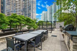 a picnic table in a park with tall buildings at Delta Suites - North York in Toronto