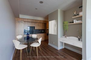 a dining room with a table and chairs in a kitchen at Delta Suites - North York in Toronto