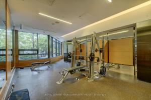 a fitness room with a gym with weights at Delta Suites - North York in Toronto