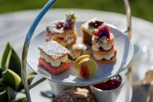 a plate of food on a table with desserts at Watersmeet Hotel in Woolacombe
