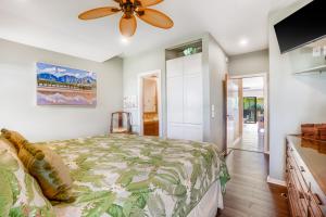 a bedroom with a bed and a ceiling fan at "Coconut Coast Beauty" Oceanview at Lae Nani 338 With AC in Kapaa +35 photos