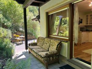 a couch sitting on the porch of a house at Ferienwohnung Sonneck in Altenahr