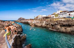 a group of people swimming in a body of water at Modern Luxury Canarian House in Garachico