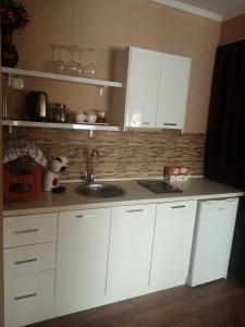 a kitchen with white cabinets and a sink at Villa sv.Petka-Ohrid in Ohrid