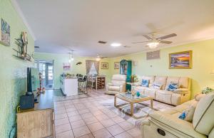 a living room with a couch and a table at Waterfront Hernando Beach Home with Dock and Hot Tub! in Hernando Beach