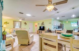 a dining room and living room with a table and chairs at Waterfront Hernando Beach Home with Dock and Hot Tub! in Hernando Beach