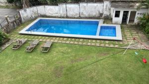 an overhead view of a pool with three lounge chairs at two flat in Douala