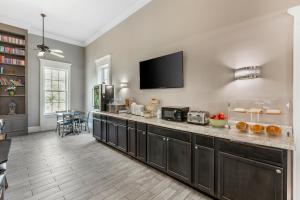 a kitchen with a large counter with a tv on the wall at Quality Inn & Suites in Santee