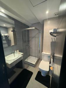 a bathroom with a shower and a toilet and a sink at welcome to ur appr in Agadir