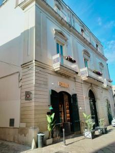 a white building with two balconies on top of it at Corte Taddeo B&B in Galatina