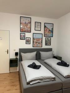 two beds in a room with pictures on the wall at Ferienwohnung Flaming House 2 in Bitterfeld