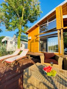 a patio with a table and chairs and a house at Dolly - Waterfront Villa no 154L in Ulcinj