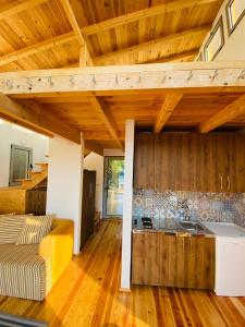 a living room with wooden ceilings and a kitchen at Dolly - Waterfront Villa no 154L in Ulcinj