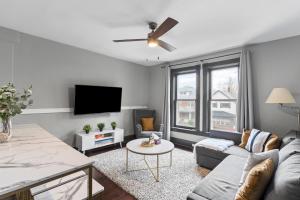 a living room with a couch and a tv at 3 bedroom with laundry and parking at Windsor in Windsor