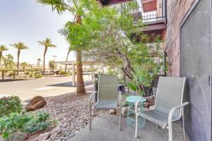 three chairs and a table in front of a building at Queens Bay Resort Condo Walk to Golf, Pool, Beach in Lake Havasu City