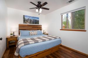 a bedroom with a bed and a ceiling fan at Yosemite Summit & Little Summit in Yosemite West