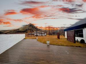 a wooden boardwalk with a mural of a mountain at Hotel Skógá by EJ Hotels in Skogar