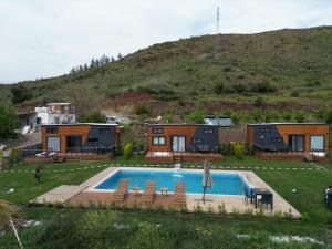 a house with a swimming pool in a yard at Kaktüs tiny house in Dalaman