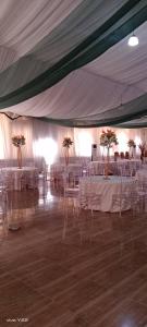a room with white tables and chairs in a tent at New View Beach Hotel and Resort Lekki Lagos in Lagos