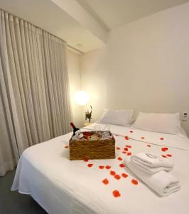 a bedroom with a bed with a box with hearts on it at Pousada Quinta da Margem in Florianópolis