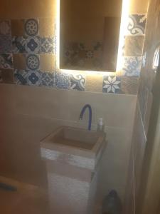 La salle de bains est pourvue d'un lavabo et d'un miroir. dans l'établissement شاليه الساحل الشمالي, à Dawwār Shindī Fannūsh
