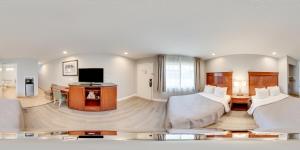 a hotel room with two beds and a flat screen tv at Quality Inn Santa Cruz Downtown Area in Santa Cruz