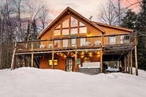 a log cabin in the woods in the snow at Gorgeous Chalet! VIEWS! Hot Tub! Sleeps 12! Games in Bethel