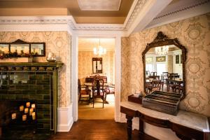 a living room with a fireplace and a mirror at Manor House Inn in Norfolk