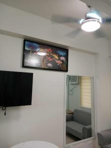 a flat screen tv on the wall of a living room at MJC's Stay and Relax in Marilao