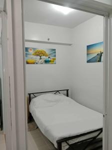 a small bedroom with a bed in a room at MJC's Stay and Relax in Marilao