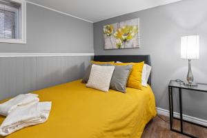 a bedroom with a yellow bed and a lamp at 2 Bedroom with Laundry and Parking in Windsor in Windsor