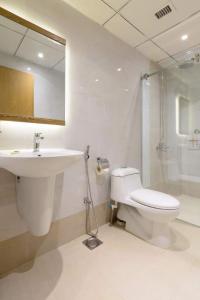 a bathroom with a toilet and a sink and a shower at RoyalVilla Guest House Karachi in Karachi